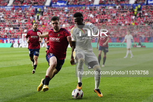 Vinicius Junior left winger of Real Madrid and Brazil and Ruben Garcia left winger of Osasuna and Spain compete for the ball during the LaLi...