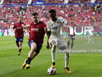 Vinicius Junior left winger of Real Madrid and Brazil and Ruben Garcia left winger of Osasuna and Spain compete for the ball during the LaLi...