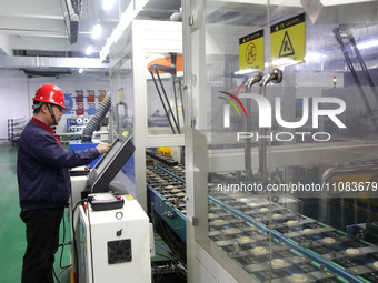 A worker is producing textile foreign trade products on a workshop production line at a spandex company workshop in the Lianyungang Economic...