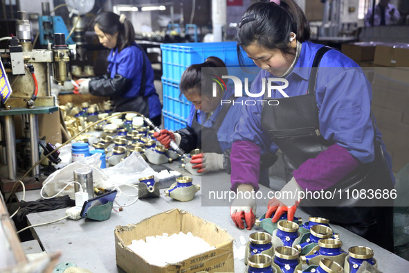 A worker is producing foreign trade products on a workshop production line at a spandex company in the Lianyungang Economic and Technologica...