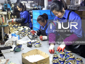 A worker is producing foreign trade products on a workshop production line at a spandex company in the Lianyungang Economic and Technologica...