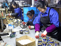 A worker is producing foreign trade products on a workshop production line at a spandex company in the Lianyungang Economic and Technologica...