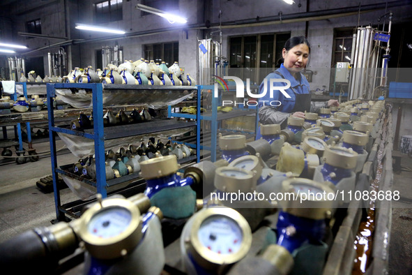 A worker is producing foreign trade products on a workshop production line at a spandex company in the Lianyungang Economic and Technologica...