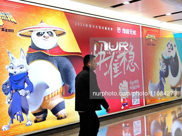 Passengers are walking past a light box advertising ''looking for jobs'' at Dawanglu Metro station in Beijing, China, on March 17, 2024. 