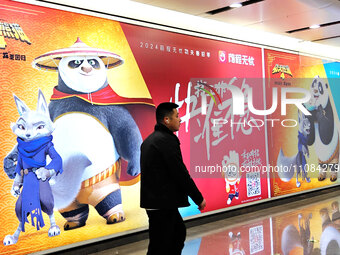 Passengers are walking past a light box advertising ''looking for jobs'' at Dawanglu Metro station in Beijing, China, on March 17, 2024. (