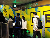 Passengers are walking past a light box advertising ''looking for jobs'' at Dawanglu Metro station in Beijing, China, on March 17, 2024. (