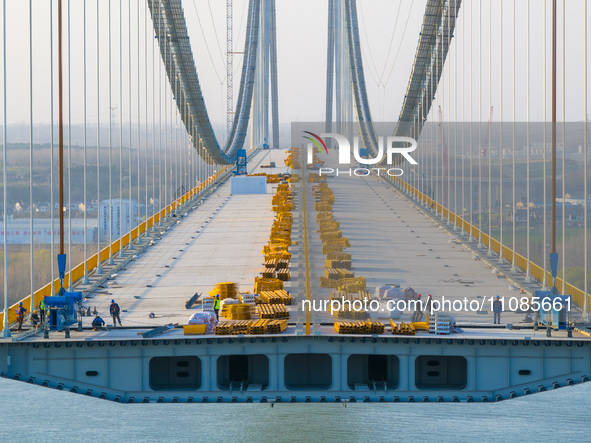 Workers are working at the construction site of the main bridge of the Longtan Yangtze River Bridge in Nanjing, Jiangsu Province, China, on...