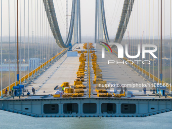 Workers are working at the construction site of the main bridge of the Longtan Yangtze River Bridge in Nanjing, Jiangsu Province, China, on...