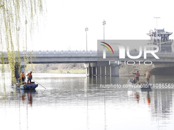 Cleaners are cleaning garbage on the Bian River to mark the upcoming World Water Day in Suqian, Jiangsu Province, China, on March 20, 2024....