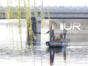 Cleaners are cleaning garbage on the Bian River to mark the upcoming World Water Day in Suqian, Jiangsu Province, China, on March 20, 2024....