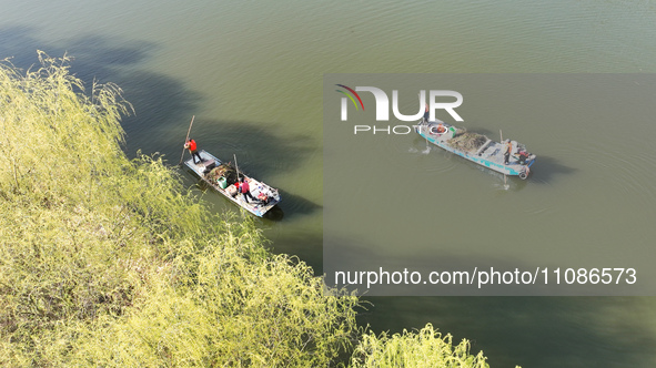 Cleaners are cleaning garbage on the Bian River to mark the upcoming World Water Day in Suqian, Jiangsu Province, China, on March 20, 2024. 