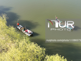 Cleaners are cleaning garbage on the Bian River to mark the upcoming World Water Day in Suqian, Jiangsu Province, China, on March 20, 2024....