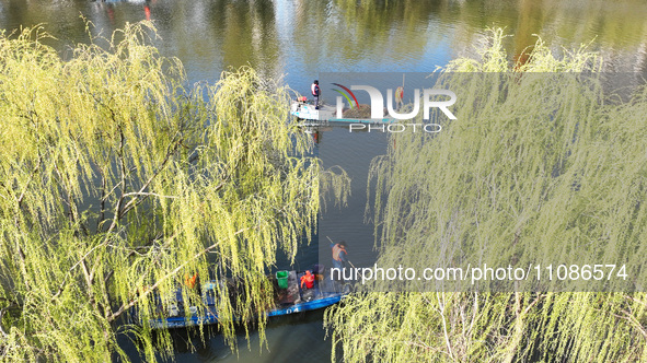 Cleaners are cleaning garbage on the Bian River to mark the upcoming World Water Day in Suqian, Jiangsu Province, China, on March 20, 2024. 