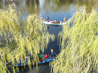 Cleaners are cleaning garbage on the Bian River to mark the upcoming World Water Day in Suqian, Jiangsu Province, China, on March 20, 2024....