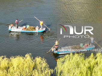 Cleaners are cleaning garbage on the Bian River to mark the upcoming World Water Day in Suqian, Jiangsu Province, China, on March 20, 2024....