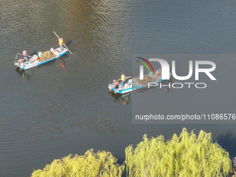 Cleaners are cleaning garbage on the Bian River to mark the upcoming World Water Day in Suqian, Jiangsu Province, China, on March 20, 2024....