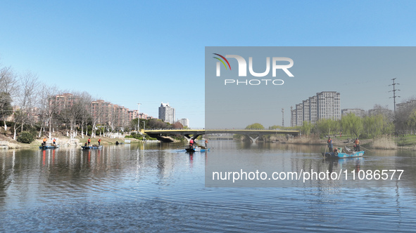 Cleaners are cleaning garbage on the Bian River to mark the upcoming World Water Day in Suqian, Jiangsu Province, China, on March 20, 2024. 