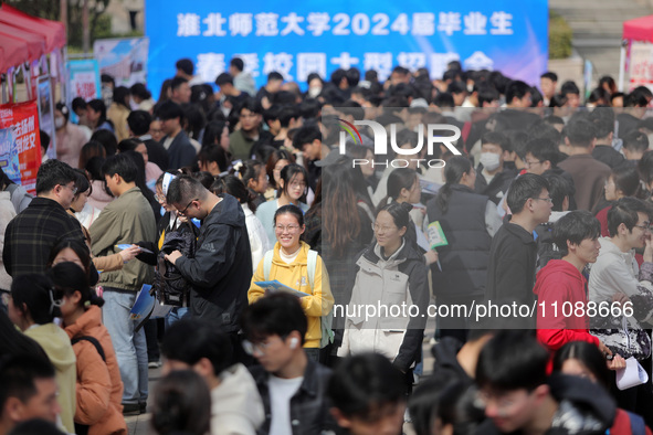 College students are looking for jobs at a spring job fair at Siyuan Square on the Xiangshan campus of Huaibei Normal University in Huaibei,...