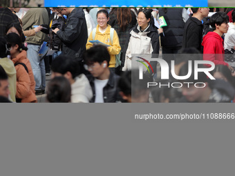 College students are looking for jobs at a spring job fair at Siyuan Square on the Xiangshan campus of Huaibei Normal University in Huaibei,...