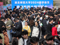 College students are looking for jobs at a spring job fair at Siyuan Square on the Xiangshan campus of Huaibei Normal University in Huaibei,...