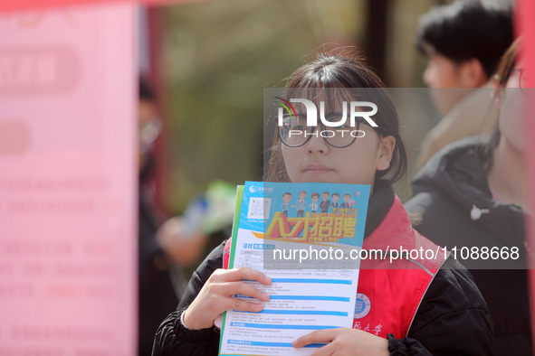 College students are looking for jobs at a spring job fair at Siyuan Square on the Xiangshan campus of Huaibei Normal University in Huaibei,...