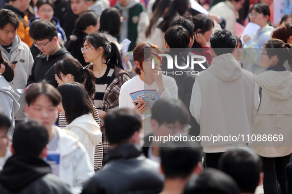 College students are looking for jobs at a spring job fair at Siyuan Square on the Xiangshan campus of Huaibei Normal University in Huaibei,...