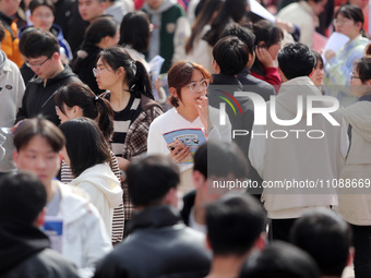 College students are looking for jobs at a spring job fair at Siyuan Square on the Xiangshan campus of Huaibei Normal University in Huaibei,...