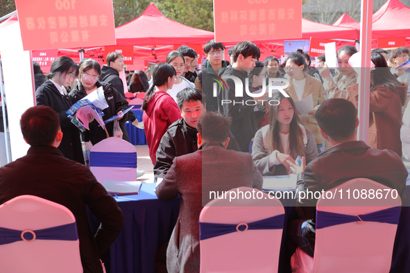 College students are looking for jobs at a spring job fair at Siyuan Square on the Xiangshan campus of Huaibei Normal University in Huaibei,...