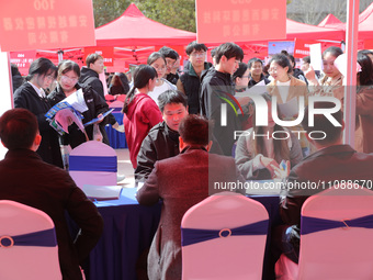 College students are looking for jobs at a spring job fair at Siyuan Square on the Xiangshan campus of Huaibei Normal University in Huaibei,...