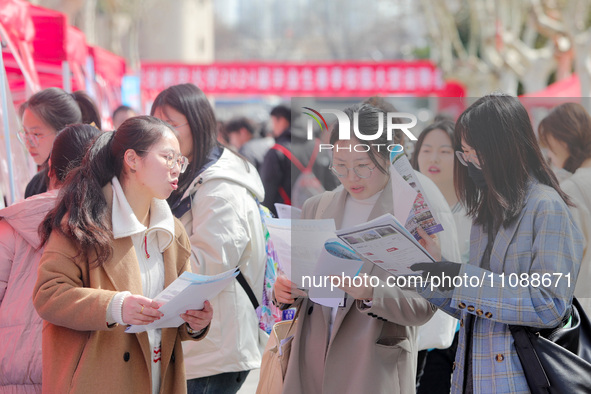 College students are looking for jobs at a spring job fair at Siyuan Square on the Xiangshan campus of Huaibei Normal University in Huaibei,...