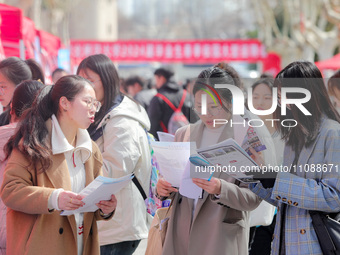 College students are looking for jobs at a spring job fair at Siyuan Square on the Xiangshan campus of Huaibei Normal University in Huaibei,...