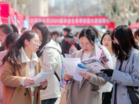 College students are looking for jobs at a spring job fair at Siyuan Square on the Xiangshan campus of Huaibei Normal University in Huaibei,...