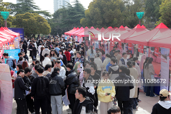 College students are looking for jobs at a spring job fair at Siyuan Square on the Xiangshan campus of Huaibei Normal University in Huaibei,...