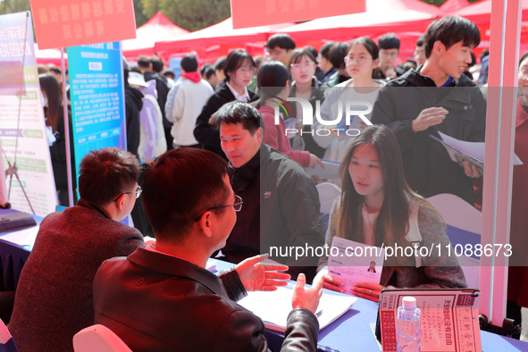 College students are looking for jobs at a spring job fair at Siyuan Square on the Xiangshan campus of Huaibei Normal University in Huaibei,...