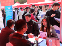 College students are looking for jobs at a spring job fair at Siyuan Square on the Xiangshan campus of Huaibei Normal University in Huaibei,...