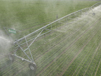 A farmer is using a water-saving pivot sprinkler for spring irrigation in Zouping, China, on March 21, 2024. (