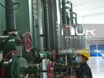 A power plant worker is checking the backwashing water of an ultrafiltration device in Zouping, Shandong Province, China, on March 21, 2024....