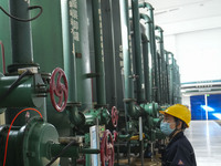 A power plant worker is checking the backwashing water of an ultrafiltration device in Zouping, Shandong Province, China, on March 21, 2024....