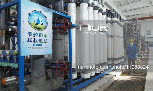 A power plant worker is walking past an ion exchanger that enables the reuse of return water in Zouping, Shandong Province, China, on March...