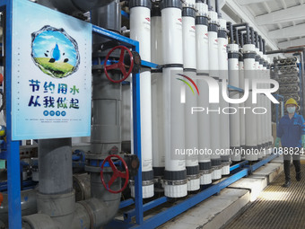 A power plant worker is walking past an ion exchanger that enables the reuse of return water in Zouping, Shandong Province, China, on March...