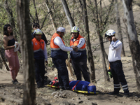 Members of Civil Protection are rescuing a person who suffered a fall while climbing Cerro de la Estrella in the Iztapalapa mayor's office i...