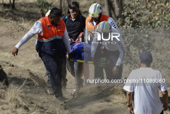 Members of Civil Protection are rescuing a person who suffered a fall while climbing Cerro de la Estrella in the Iztapalapa mayor's office i...