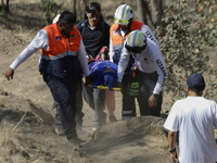 Members of Civil Protection are rescuing a person who suffered a fall while climbing Cerro de la Estrella in the Iztapalapa mayor's office i...