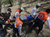 Members of Civil Protection are rescuing a person who suffered a fall while climbing Cerro de la Estrella in the Iztapalapa mayor's office i...