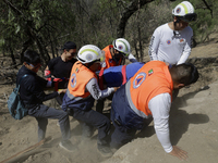 Members of Civil Protection are rescuing a person who suffered a fall while climbing Cerro de la Estrella in the Iztapalapa mayor's office i...