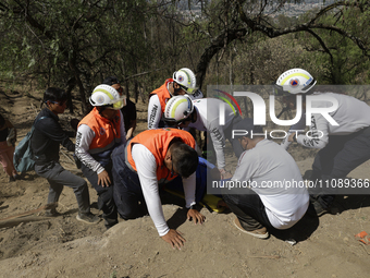 Members of Civil Protection are rescuing a person who suffered a fall while climbing Cerro de la Estrella in the Iztapalapa mayor's office i...