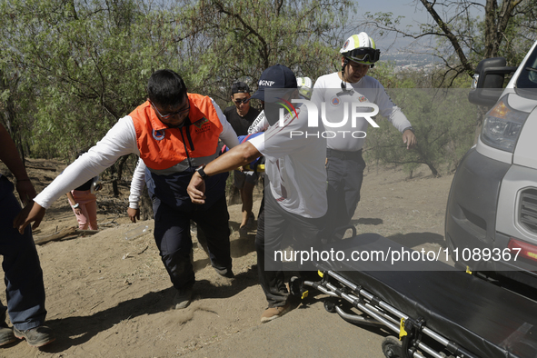 Members of Civil Protection are rescuing a person who suffered a fall while climbing Cerro de la Estrella in the Iztapalapa mayor's office i...