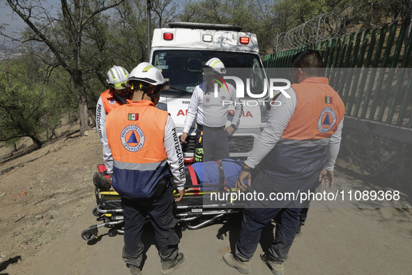 Members of Civil Protection are rescuing a person who suffered a fall while climbing Cerro de la Estrella in the Iztapalapa mayor's office i...