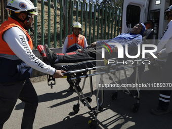 Members of Civil Protection are rescuing a person who suffered a fall while climbing Cerro de la Estrella in the Iztapalapa mayor's office i...