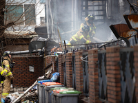 Firefighters are extinguishing a fire that has broken out at the commercial complex of Yeouido Gongjak Apartments in Seoul, South Korea, on...